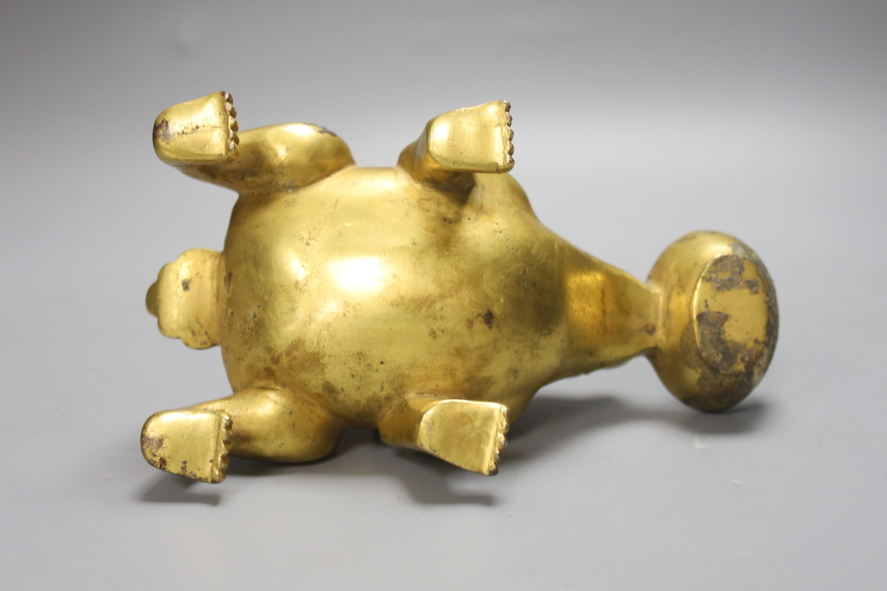 A Chinese gilt bronze mythical beast lamp, width 16cm